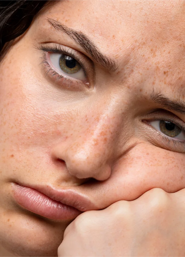 Woman resting her face on her hand