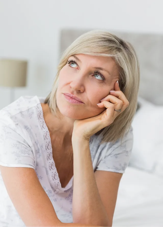 Tired woman resting her head on her hand