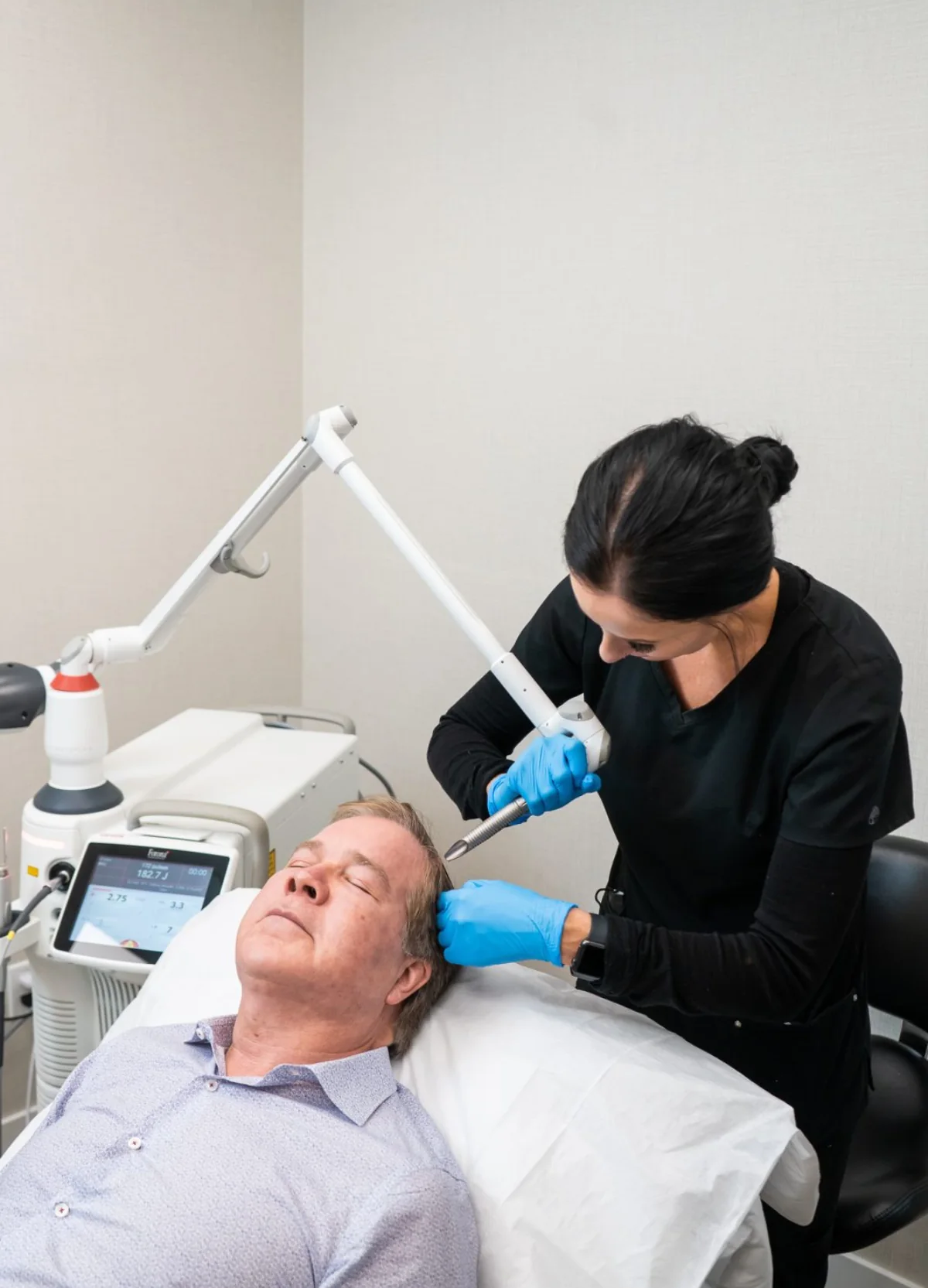 Male patient receiving a Fotona scalp treatment at Advanced Aesthetics