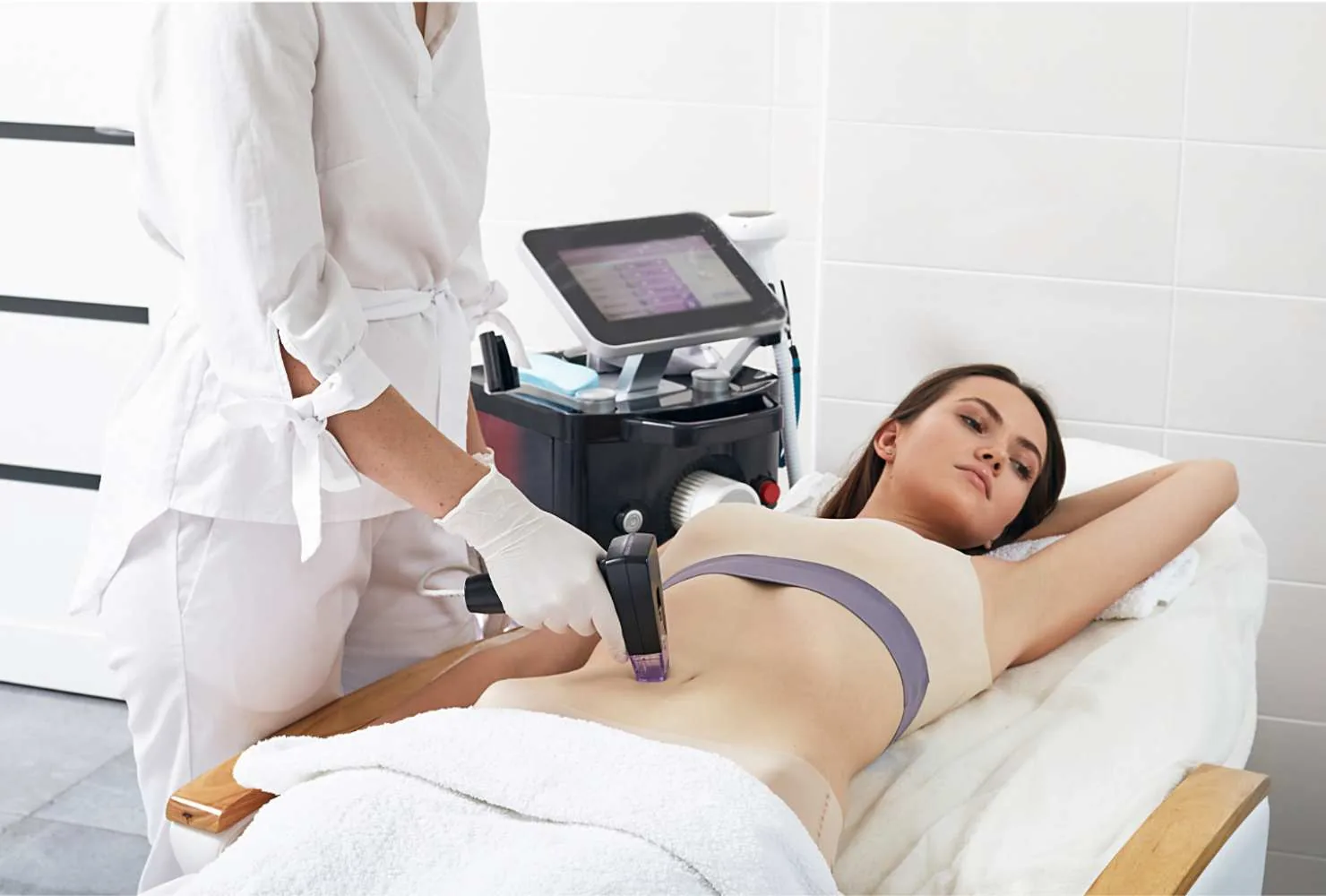 Provider treating a patient’s abdomen with an RF microneedling handpiece