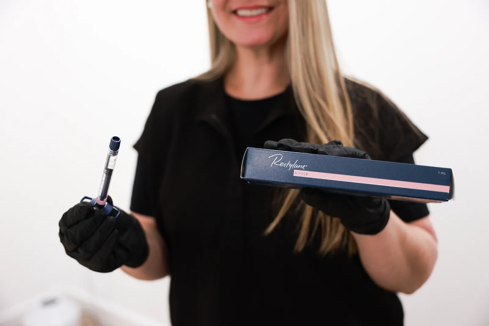 Advanced Aesthetics injector holding Restylane filler, Medford and Braintree MA