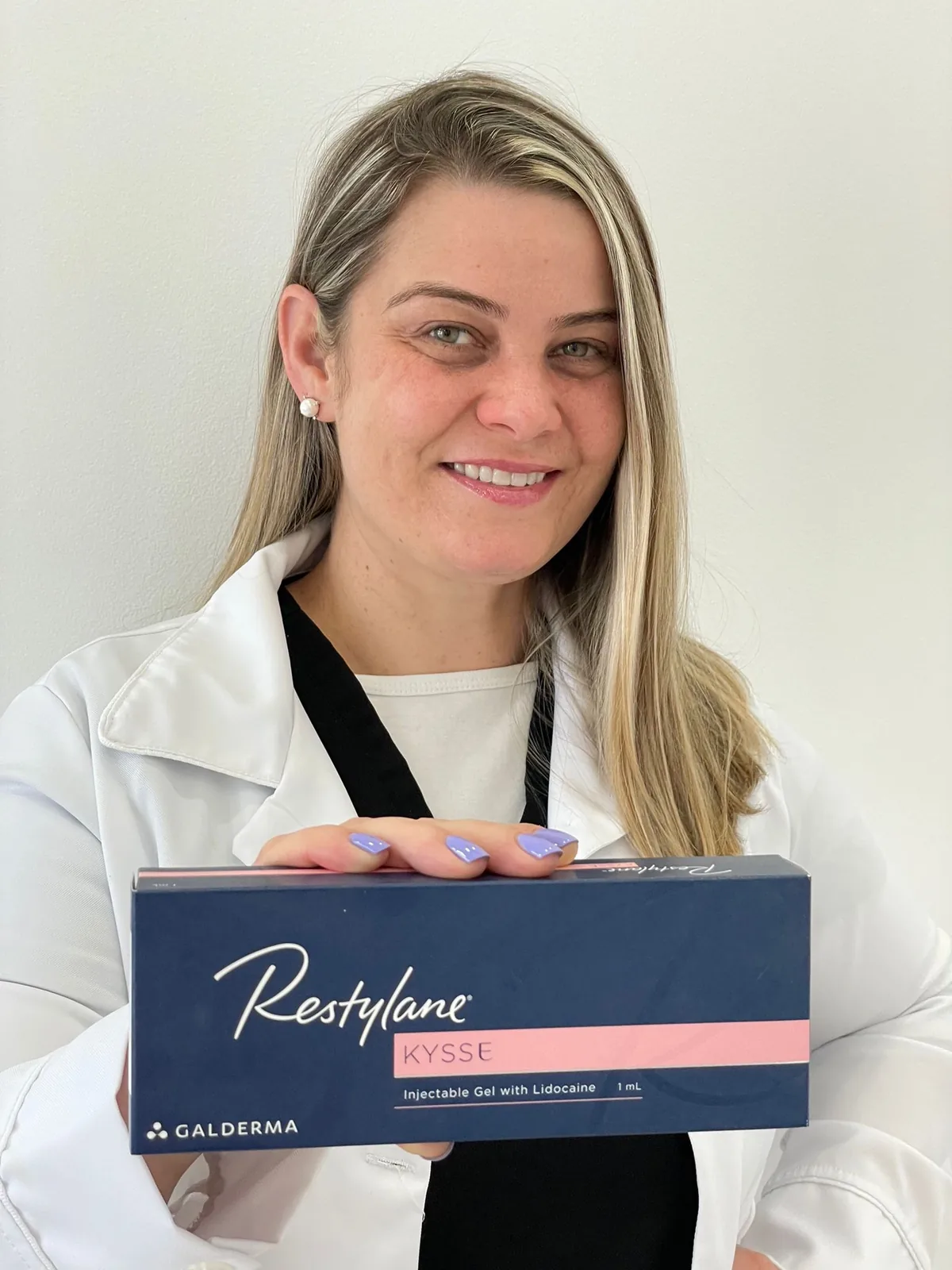 Advanced Aesthetics provider holding a box of Restylane