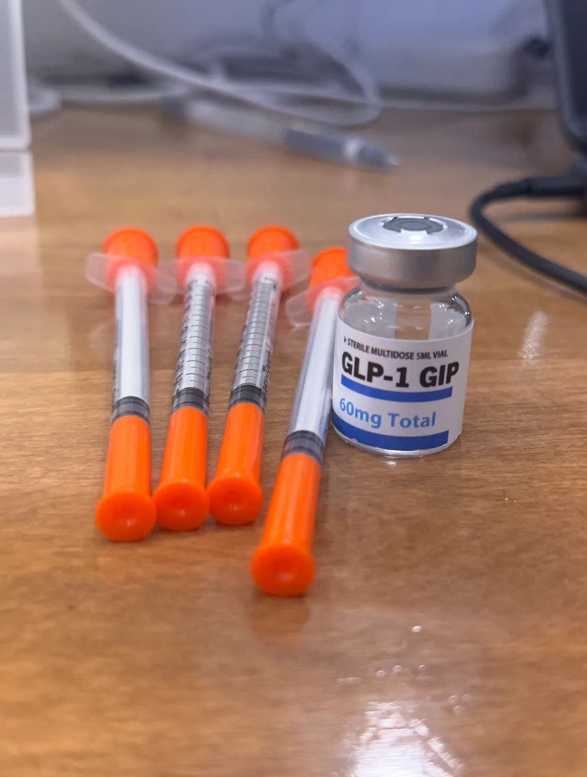 GLP-1 medication vial and syringes at Advanced Aesthetics