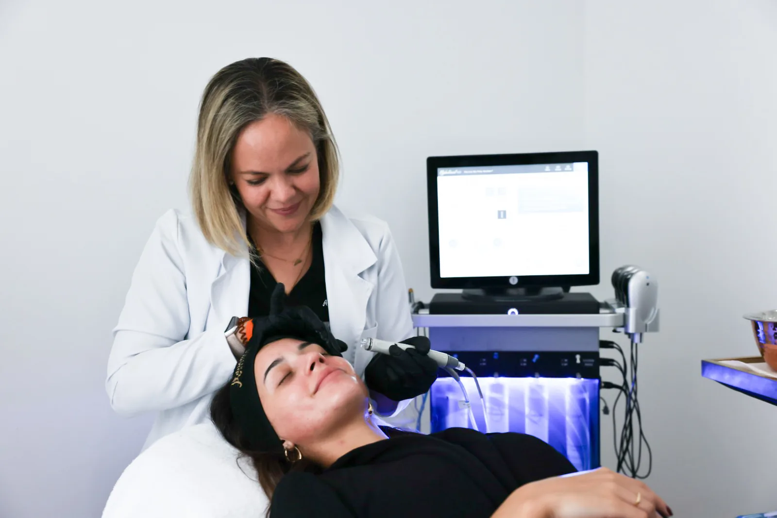 Provider giving a HydraFacial in the treatment room at Advanced Aesthetics, Medford and Braintree MA